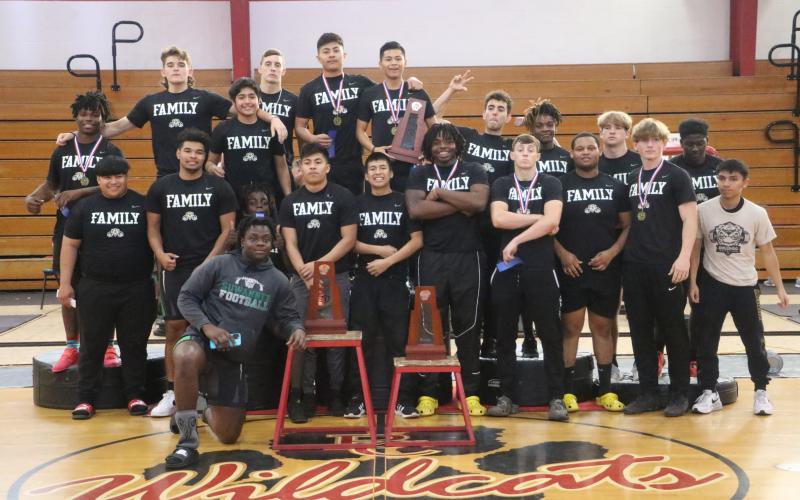 Suwannee's boys weightlifting team poses with the District 3-2A trophies after winning titles in the traditional and snatch on Thursday. (MORGAN MCMULLEN/Lake City Reporter)