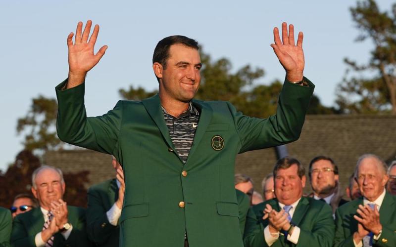Scottie Scheffler celebrates after putting on the green jacket after winning the 86th Masters on Sunday in Augusta, Ga. (DAVID J. PHILLIP/Associated Press)