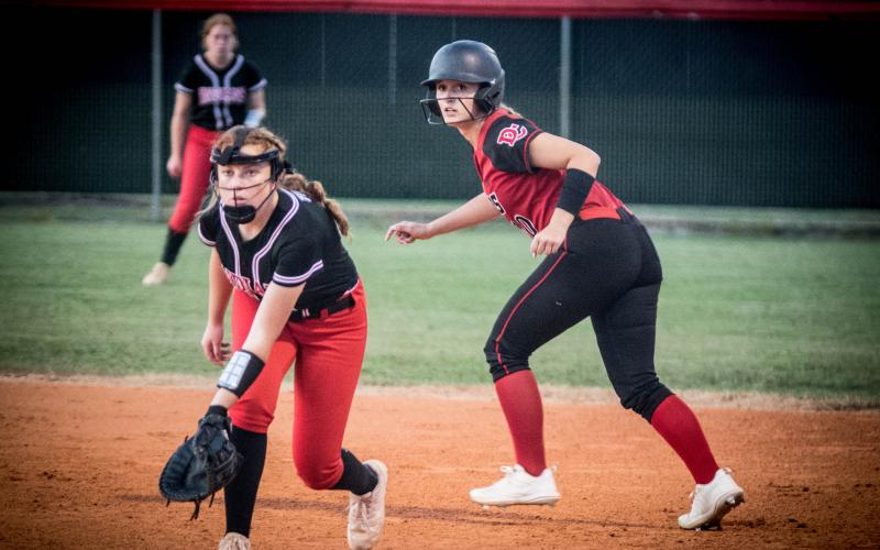 Fort White first baseman Hannah Brown tries to hold a Dixie County runner at first base during the Indians’ 2-1 loss Thursday night. (CHRISTINA FEAGIN/Special to the Reporter)