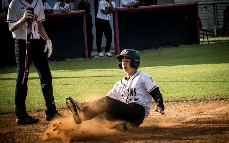 Fort White's Garrett Depaola slides safely into home plate to score a run against Taylor County on Thursday night. (CHRISTINA FEAGIN/Special to the Reporter)
