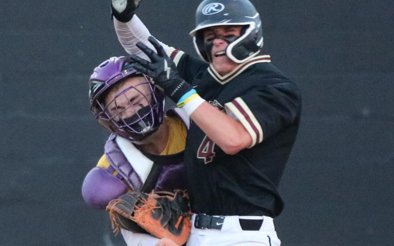 Columbia catcher Hayden Gustavson tags out St. Augustine’s Merrick Beamish during Thursday’s District 3-5A championship game. Beamish was ejected for throwing an elbow Toward Gustavson’s face. (JORDAN KROEGER/Lake City Reporter)