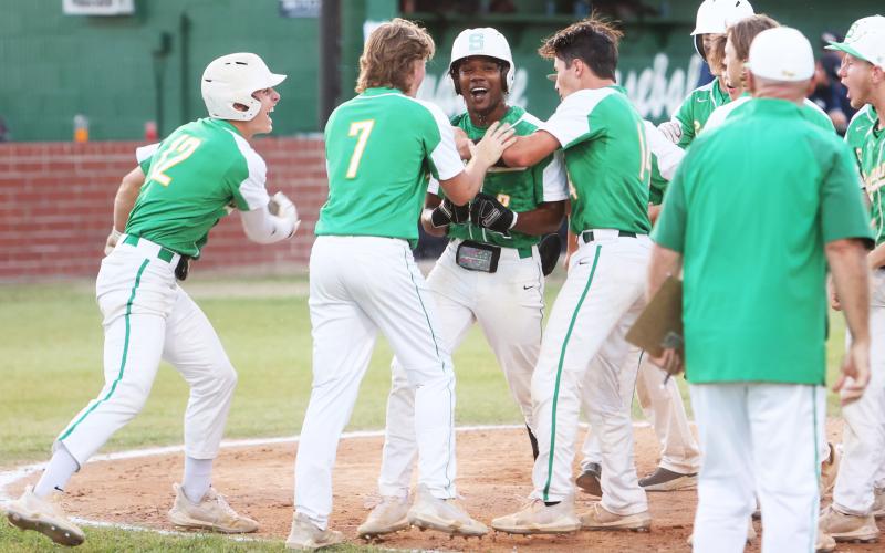 Suwannee’s Malachi Graham celebrates with his team at home plate after hitting a home run against Wakulla during the District 2-4A championship on Thursday. (PAUL BUCHANAN/Special to the Reporter)