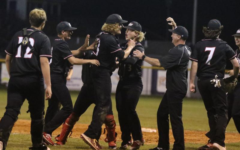 Fort White players celebrate after defeating Union County in the Region 3-1A semifinals on Tuesday. (MORGAN MCMULLEN/Lake City Reporter)