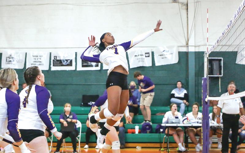 Former Columbia volleyball player Brandi Oliver rises up to hit against Fort White last season on Senior Night. (FILE)