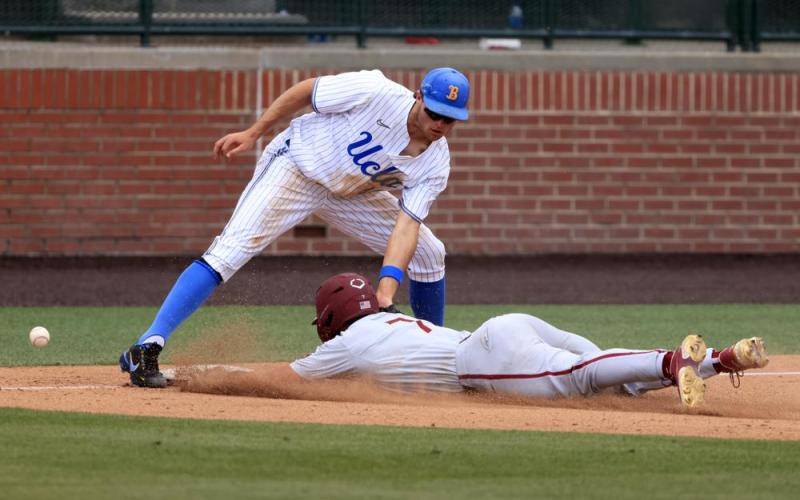 UCLA infielder Kyle Karros mishandles the ball as Florida State's Jaime Ferrer slides safely into third base on Friday in Auburn, Ala. (BUTCH DILL/Associated Press)