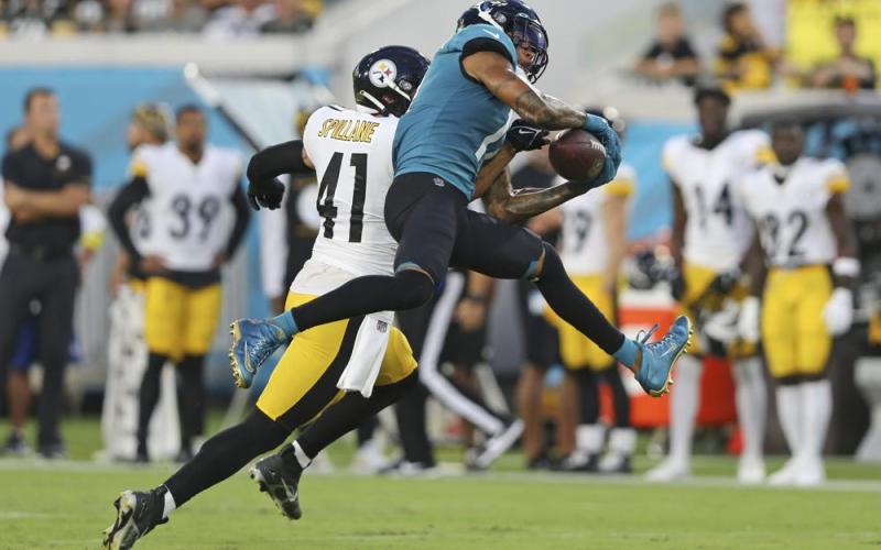 Jacksonville Jaguars wide receiver Marvin Jones Jr. (right) makes a reception in front of Pittsburgh Steelers linebacker Robert Spillane during Saturday’s preseason game in Jacksonville. (GARY MCCULLOUGH/Associated Press)