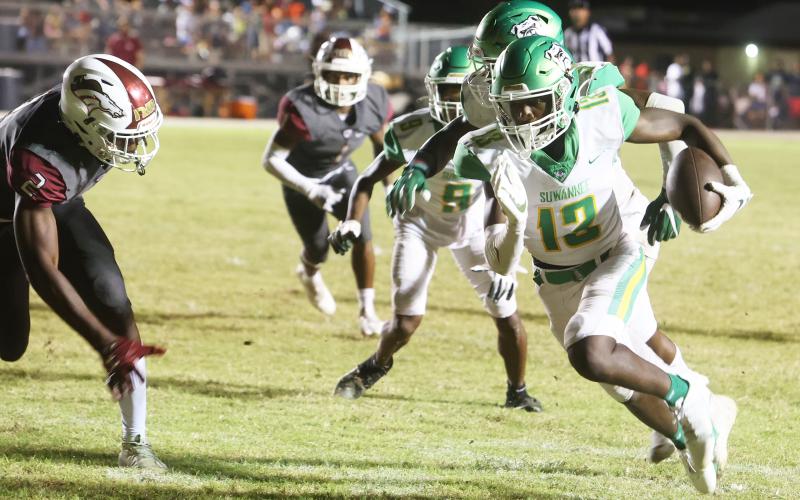 Suwannee defensive back PJ Davis scores on a pick-6 in the third quarter Friday against North Marion. (PAUL BUCHANAN/Special to the Reporter)