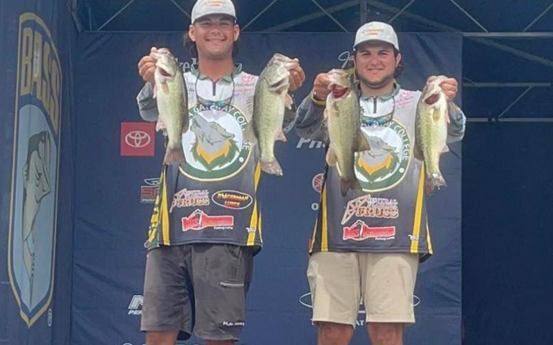 Seth Slanker (left) and Jackson Swisher show off their catches at the 2022 Strike King Bassmaster College Series National Championship. (COURTESY FGC)