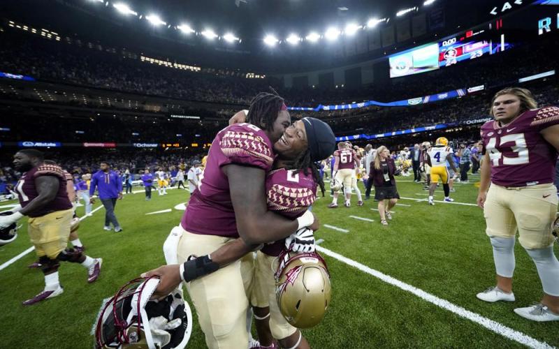 Florida State running back Treshaun Ward (8) celebrates with offensive lineman Darius Washington (76) after defeating LSU on a blocked extra point with no time remaining on Sunday in New Orleans. Florida State won 24-23. (GERALD HERBERT/Associated Press)
