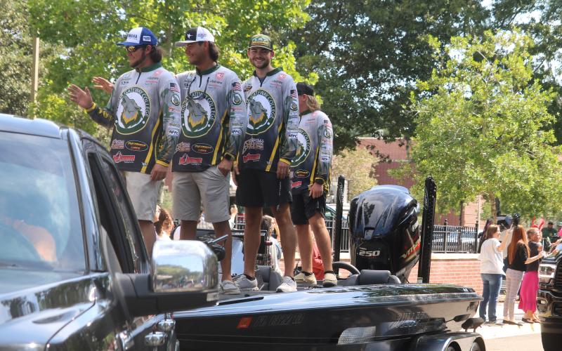 Florida Gateway College’s national runner-up fishing duo Jackson Swisher (from left) and Seth Slanker wave with teammates during a parade on the college campus Thursday celebrating the FGC fishing club’s national tournament success. (TONY BRITT/Lake City Reporter)