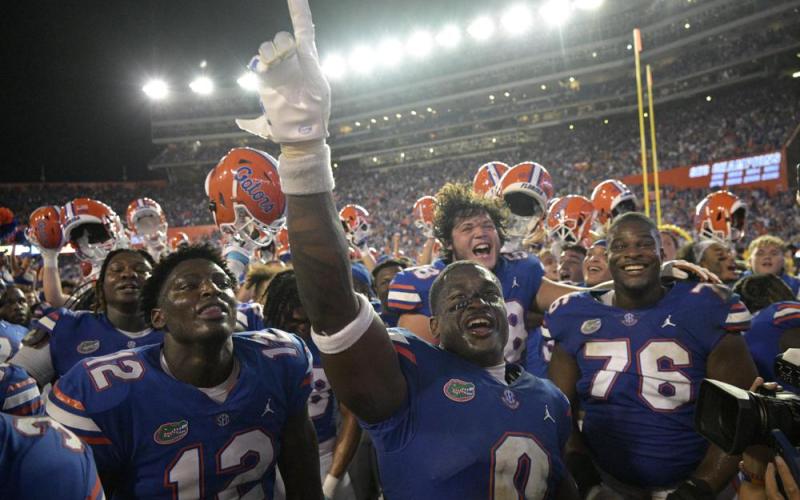 Florida safety Trey Dean III (0) and teammates celebrate after defeating Utah on Saturday in Gainesville. (PHELAN M. EBENHACK/Associated Press)