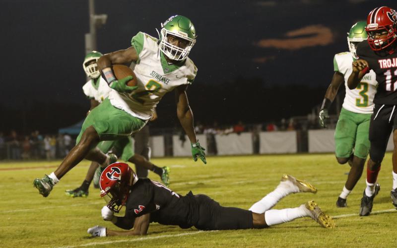 Suwannee’s Jay Smith leaps over a Hamilton County player on a punt return Friday night at Veterans Memorial Stadium. (JAMIE WACHTER/Lake City Reporter)