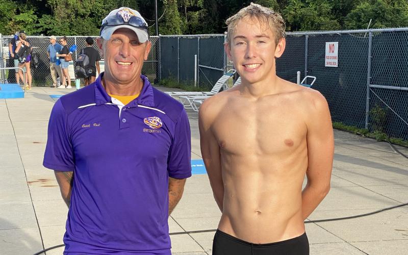 Columbia swimmer Ian Disosway (right) broke the school record in the 100 breaststroke during Thursday’s meet against Baker County. Disosway is pictured with Columbia head coach Shawn Rost. (COURTESY)