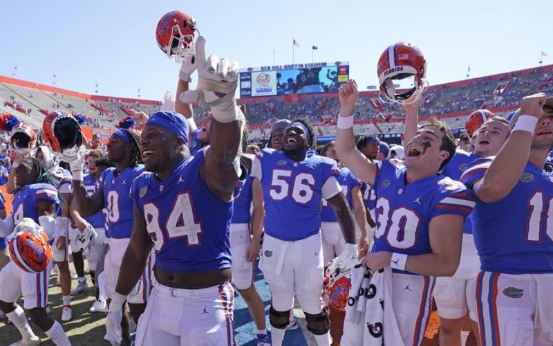 Florida players celebrate in front of fans after defeating Missouri on Saturday in Gainesville. (JOHN RAOUX/Associated Press)