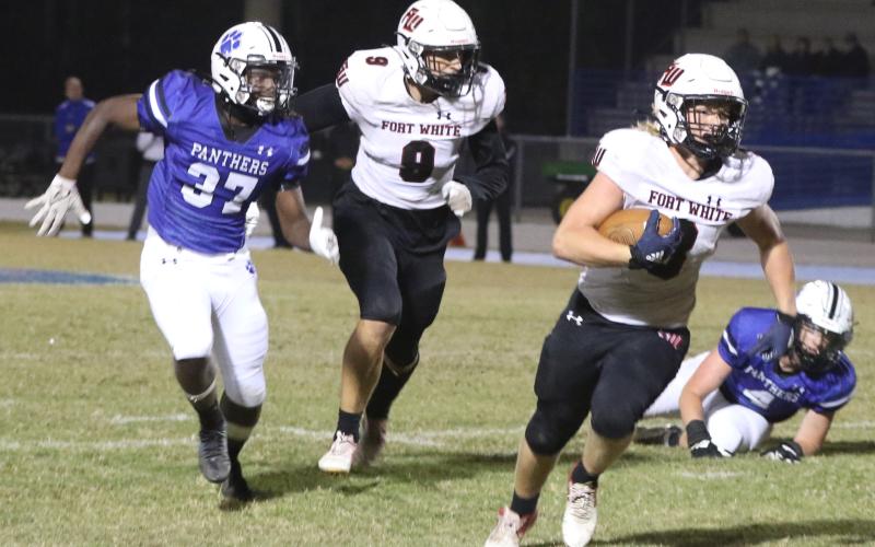 Fort White fullback Hayden Adams rushes past the Ridgeview defense on Friday night. (MORGAN MCMULLEN/Lake City Reporter)