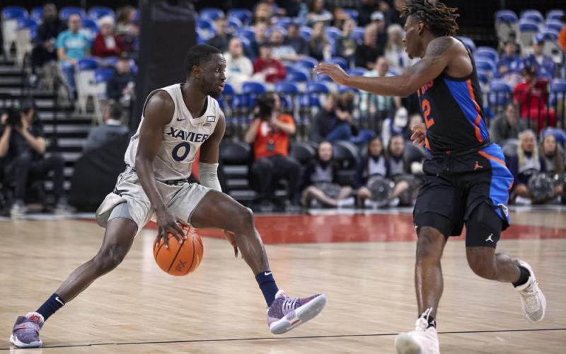 Xavier guard Souley Boum (left) is defended by Florida guard Trey Bonham during the opening round of the Phil Knight Legacy on Thursday in Portland, Ore. (CRAIG MITCHELLDYER/Associated Press)