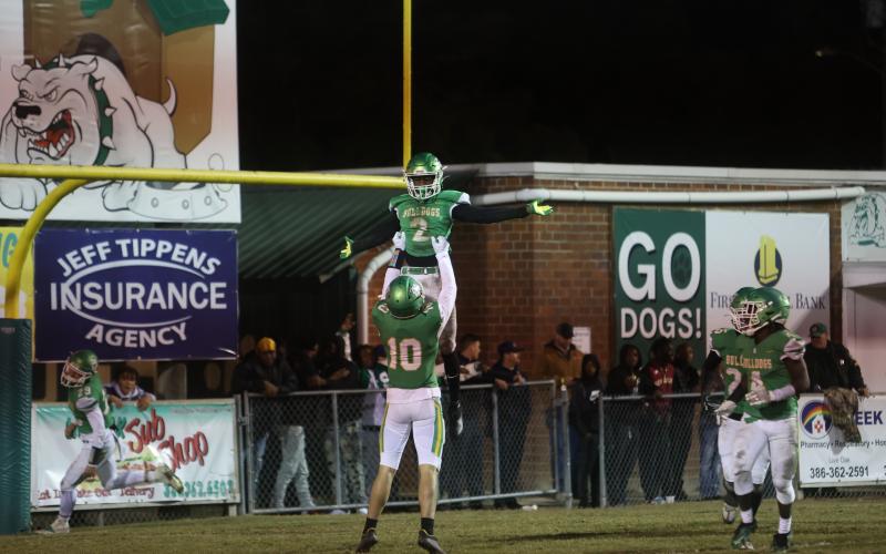 Suwannee wide receiver Kodi Lang lifts teammate Jay Smith into the air after Smith caught the go-ahead touchdown in the fourth quarter Friday night against West Florida. (PAUL BUCHANAN/Special to the Reporter)