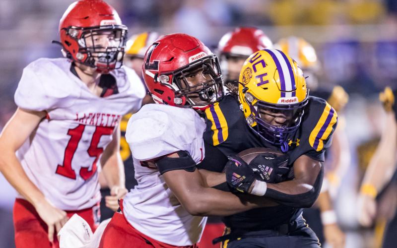 Union County running back Rayvon Durant fights for extra yardage against Lafayette during the Region 3-1R finals on Friday. (JACK HOWDESHELL/Special to the Reporter)
