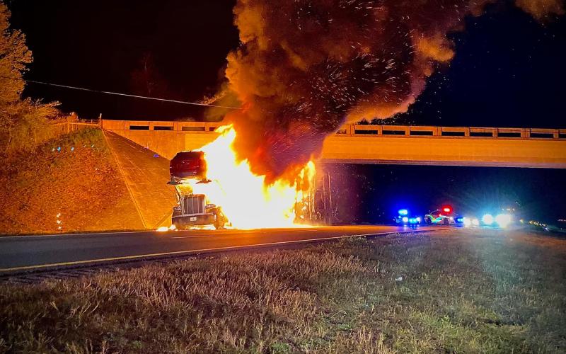 A tractor trailer transporting automobiles caught fire on Interstate 10 in Suwannee County on Thursday night, closing down the interstate for hours as firefighters battled the blaze. (COURTESY SUWANNEE FIRE RESCUE)