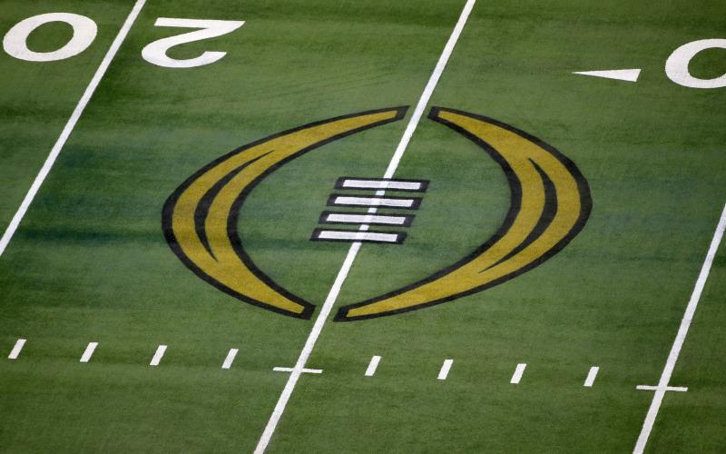 The College Football Playoff logo is shown on the field at AT&T Stadium before the Rose Bowl between Notre Dame and Alabama on Jan. 1, 2021 in Arlington, Texas. (AP FILE)