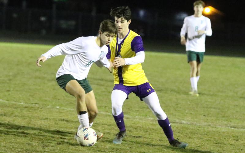 Columbia midfielder Bergen Cobb tries to steal the ball from Fleming Island’s Daniel Vizcarrondo on Wednesday night. (MORGAN MCMULLEN/Lake City Reporter)