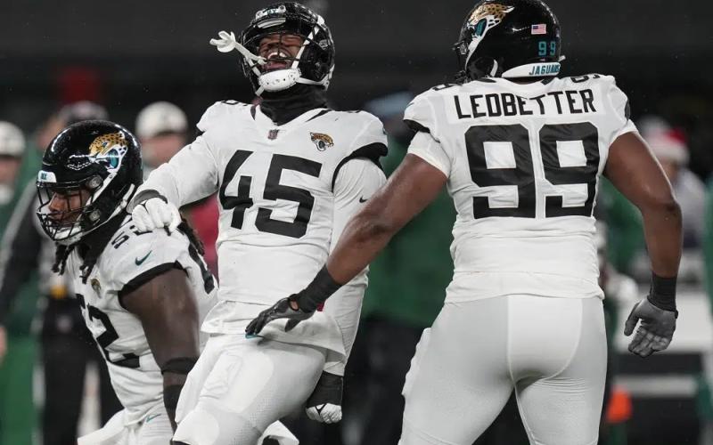 Jacksonville Jaguars linebacker K'Lavon Chaisson (45) celebrates with defensive tackle DaVon Hamilton (52) and defensive end Jeremiah Ledbetter (99) after a sack against the New York Jets on Thursday in East Rutherford, N.J. (SETH WENIG/Associated Press)