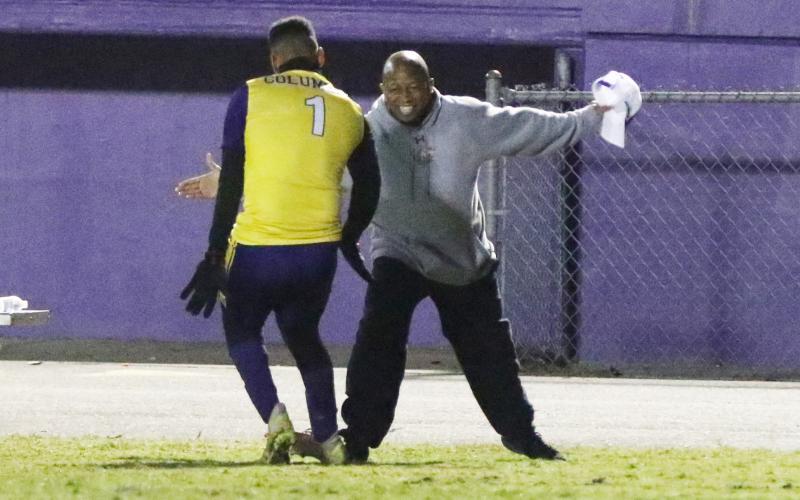 Columbia’s AJ Brinson (1) celebrates with head coach Ed Turner after scoring his first goal against Eastside on Friday night. (MORGAN MCMULLEN/Lake City Reporter)
