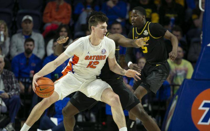 Florida forward Colin Castleton drives against Missouri guard Kobe Brown during Saturday's game in Gainesville. (ALAN YOUNGBLOOD/Associated Press)
