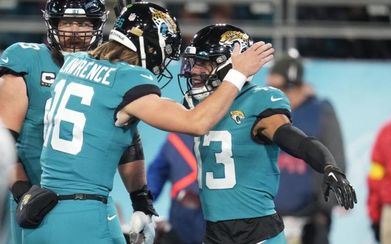 Jacksonville Jaguars wide receiver Christian Kirk (13) celebrates his touchdown reception with quarterback Trevor Lawrence (16) during Saturday's game against the Tennessee Titans in Jacksonville. (JOHN RAOUX/Associated Press)