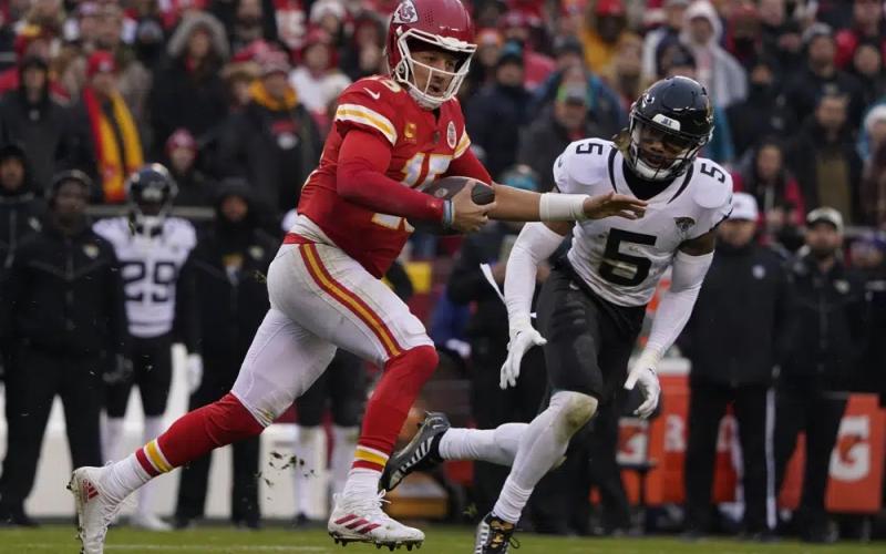 Kansas City Chiefs quarterback Patrick Mahomes runs out of the pocket as Jacksonville Jaguars safety Andre Cisco defends during Saturday's divisional playoff game in Kansas City, Mo. (ED ZURGA/Associated Press)