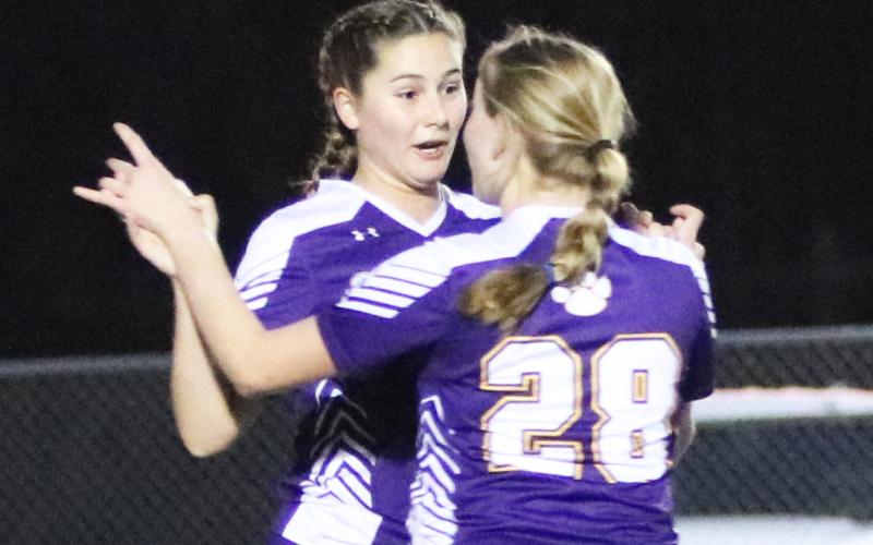 Columbia Sydney Rivas (31) celebrates with Kyndall Norris (28) after Rivas’ first of two goals against Trinity Catholic on Wednesday night. (JORDAN KROEGER/Lake City Reporter)