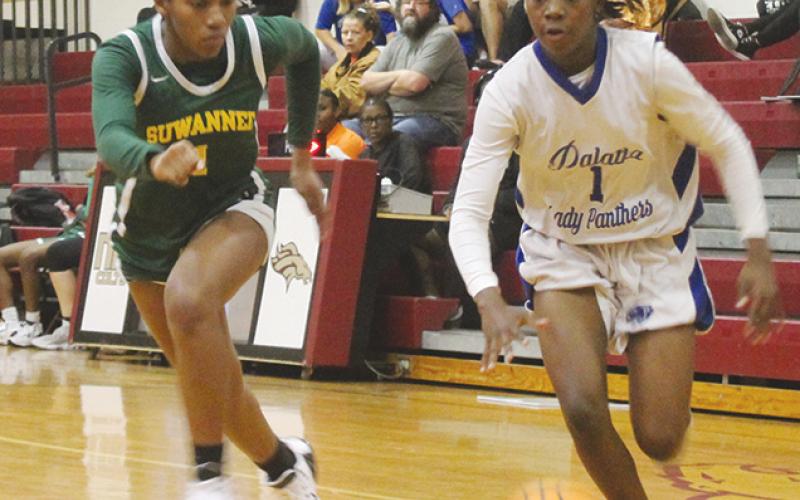 Palatka’s Jhane Fountain finds an alley to the basket as Suwannee’s Janeah Mitchell tries to keep up with her in Thursday night’s District 5-4A semifinal. (MARK BLUMENTHAL/Palatka Daily News)