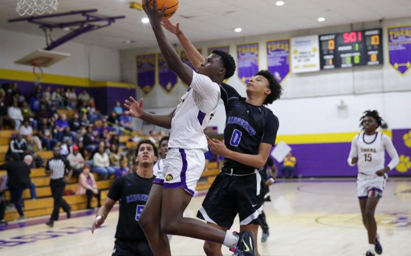 Columbia guard Isaac Broxey drives past Ridgeview’s Calen Wiggins for a layup Wednesday night in a District 2-5A tournament semifinal. (BRENT KUYKENDALL/Lake City Reporter)