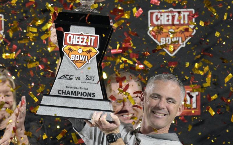 Florida State head coach Mike Norvell lifts the trophy after the team's win against Oklahoma in the Cheez-It Bowl on Dec. 29, 2022, in Orlando. (PHELAN M. EBENHACK/Associated Press)