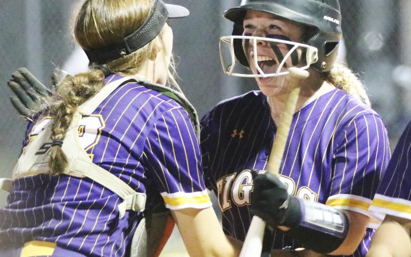 Columbia second baseman Alex Collins (right) celebrates with catcher Emily Delgado after hitting a walk-off RBI single against Taylor County on Thursday night. (JORDAN KROEGER/Lake City Reporter).
