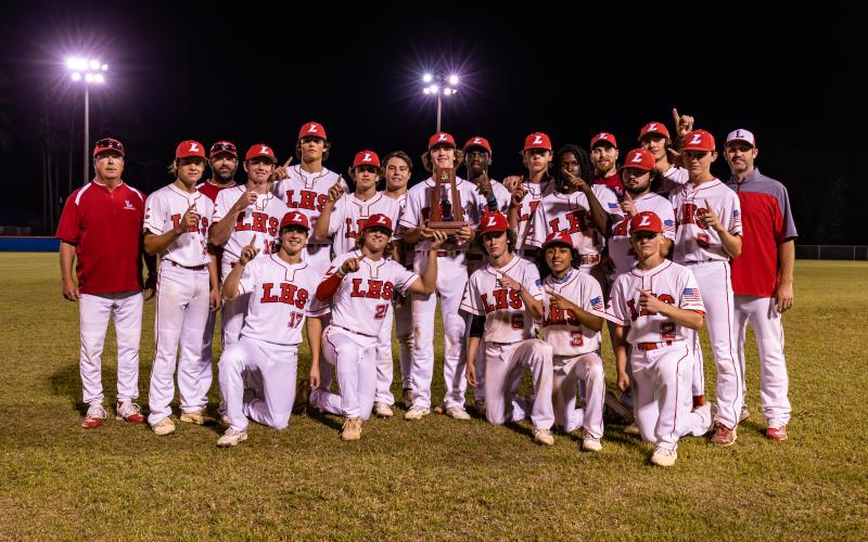 Lafayette celebrates with the District 6-1A championship trophy after defeating Union County 9-8 on Thursday night. (JACK HOWDESHELL/Special to the Reporter)