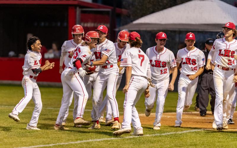 Lafayette’s Dawson Mock celebrates with teammates after hitting a grand slam against Wakulla Christian in the Region 3-1A semifinals on Wednesday night. (JACK HOWDESHELL/Special to the Reporter)