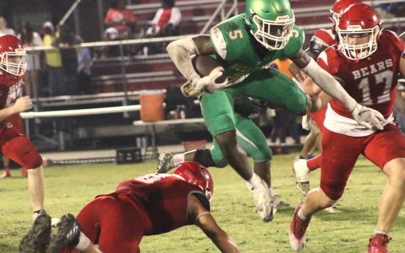 Suwannee receiver MJ Rossin jumps over a Dixie County defender Thursday night at Bruce Boyette Field. (JAMIE WACHTER/Lake City Reporter)