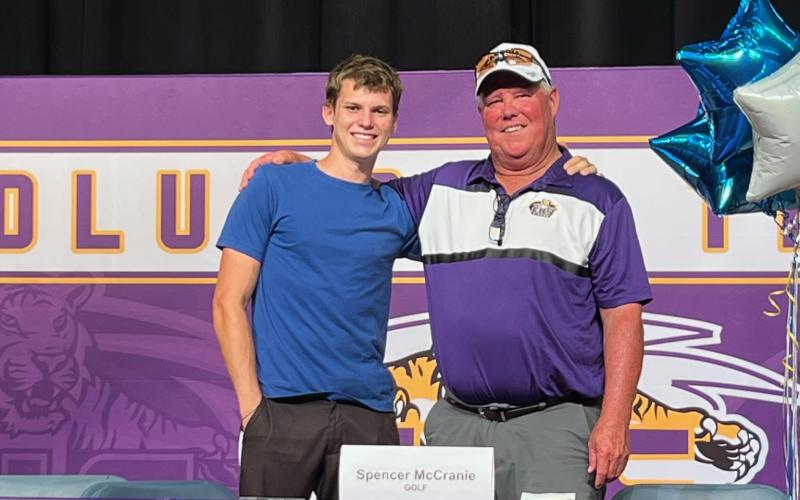 Columbia golfer Spencer McCranie (left), pictured alongside CHS head coach Sherman Reed, signed his letter of intent to play at Tennessee State University on Thursday. (COURTESY)