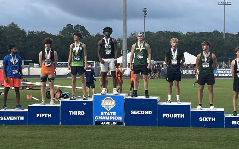 Suwannee junior Will Wainwright stands on the podium Thursday at Hodges Stadium in Jacksonville after finishing second in the javelin in Class 2A. (COURTESY)