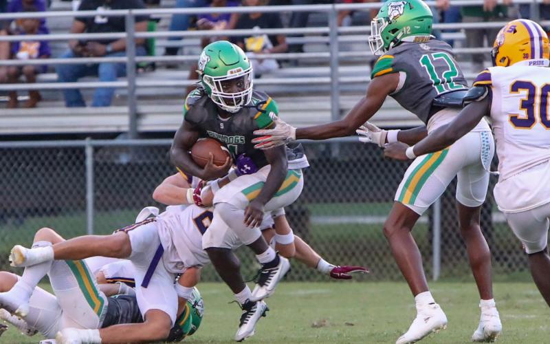 Suwannee running back Marquavious Owens tries to escape a tackle against Columbia during Friday night’s Preseason Classic. (BRENT KUYKENDALL/Lake City Reporter)