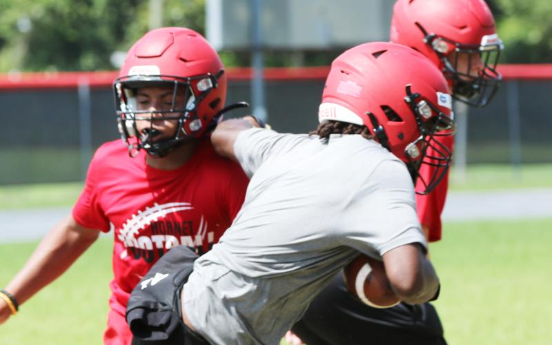 Lafayette’s Jalen Hill shakes off linebacker Trevor Mares during practice on Aug. 1. (JAMIE WACHTER/Lake City Reporter)