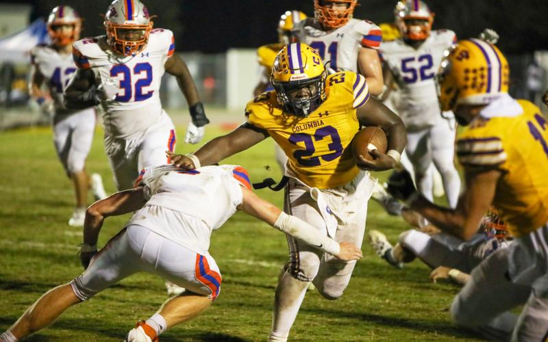 Columbia running back Jonathan Andrews stiff arms a Bolles defender on his game-winning touchdown run Friday night at Tiger Stadium. (BRENT KUYKENDALL/Lake City Reporter)
