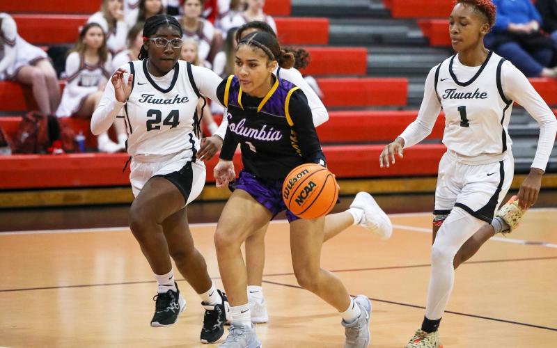 Columbia guard Mariah Cox pushes the ball up the floor in transition as Fort White guard Nahiemah Ottinot gives chase on Tuesday night. (BRENT KUYKENDALL/Lake City Reporter)