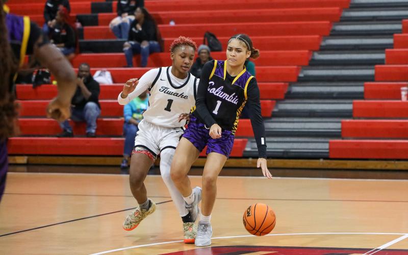 Columbia guard Mariah Cox is dribbles while being defended by Fort White forward Isreal Hart on Monday night. (BRENT KUYKENDALL/Lake City Reporter)