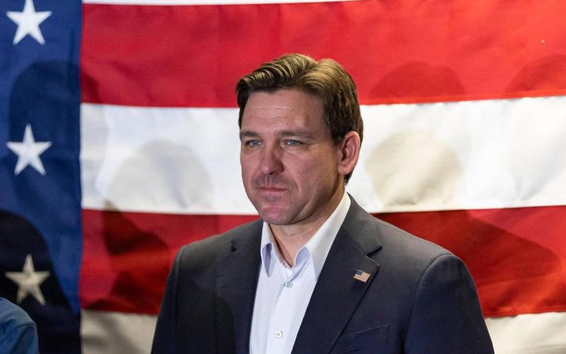 Florida Gov. Ron DeSantis listens during a rally at the Never Back Down super PAC headquarters on Saturday in West Des Moines, Iowa. (MATIAS OCNER/Miami Herald/TNS)