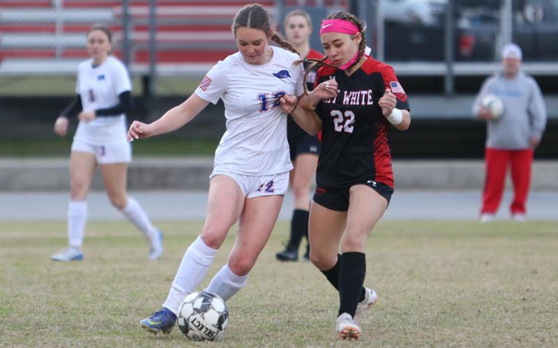 Branford's Emma Soride dribbles while being defended by Fort White's Gabriella Serrano on Jan. 13. (PAUL BUCHANAN/Special to the Reporter)