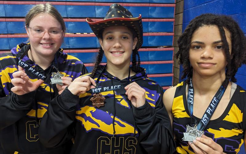 Columbia wrestlers Bella Guerrier-Lajoir (115 class), Carlee Morrison (155 class) and Josie Raulerson (235 class) all won first place at the Pace Round Robin on Saturday. (COURTESY)