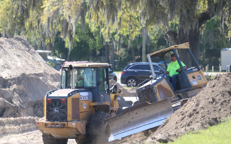 A pair of workers for Charles Peeler Construction move dirt at the site of a future Tractor Supply Co. store on East Duval Street in Lake City. Crews are currently getting the site ready for building construction. (TONY BRITT/Lake City Reporter)
