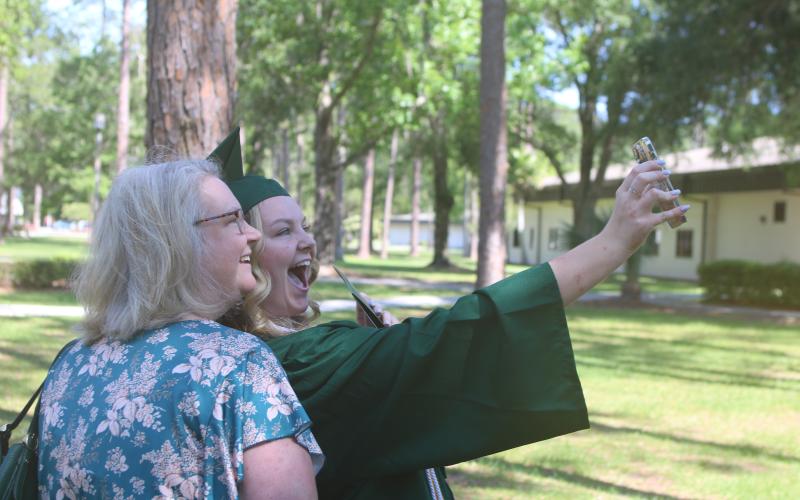 Jennifer Chaplin (from left) and her daughter Chloe Chaplin take a selfie with Chloe’s cell phone after Chloe graduated from Florida Gateway College on Friday morning at the Howard Center. (TONY BRITT/Lake City Reporter)